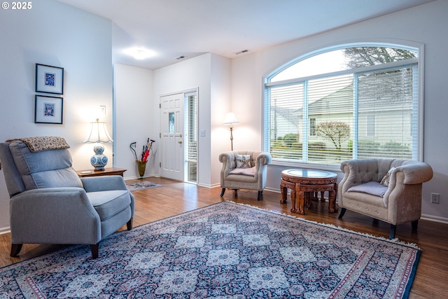 living area with hardwood / wood-style flooring