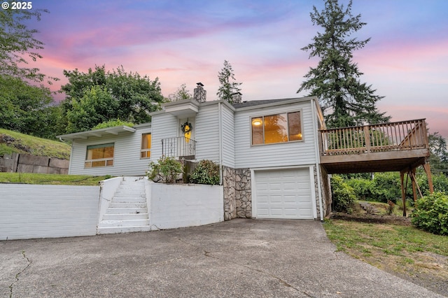 123 Scenic View Dr, Longview, WA 98632 - view of front facade with a garage, concrete driveway, stairs, a chimney, and a wooden deck