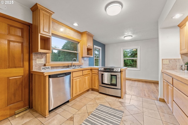 123 Scenic View Dr, Longview, WA 98632 - kitchen featuring appliances with stainless steel finishes, light countertops, open shelves, tasteful backsplash, and a peninsula