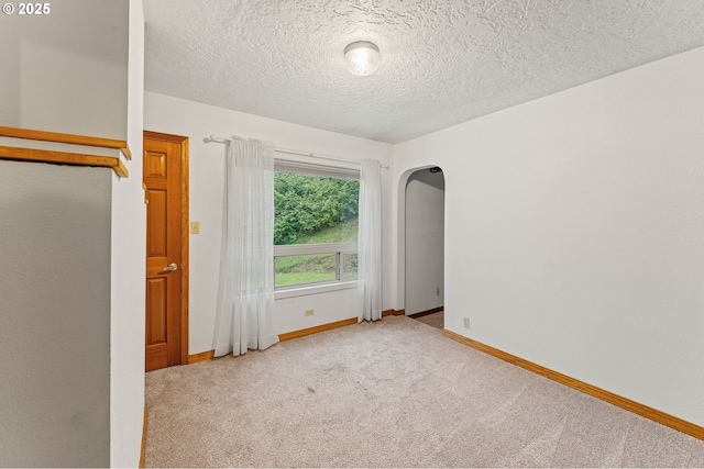 123 Scenic View Dr, Longview, WA 98632 - empty room with carpet, arched walkways, and a textured ceiling