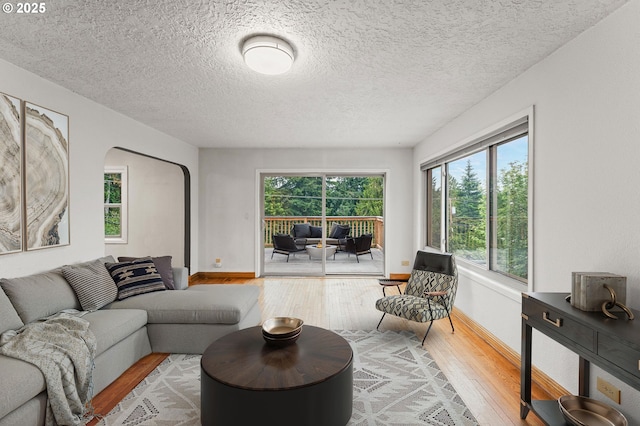 123 Scenic View Dr, Longview, WA 98632 - living room featuring hardwood / wood-style floors, arched walkways, and a textured ceiling