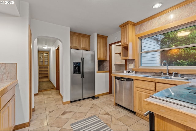 123 Scenic View Dr, Longview, WA 98632 - kitchen with stainless steel appliances, arched walkways, light countertops, and light tile patterned flooring