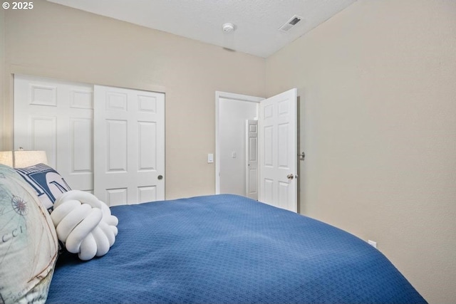 bedroom featuring a closet and visible vents