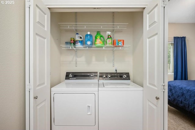 laundry room featuring washing machine and dryer and laundry area