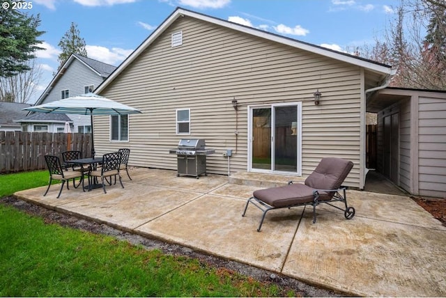 back of property featuring a patio area and fence