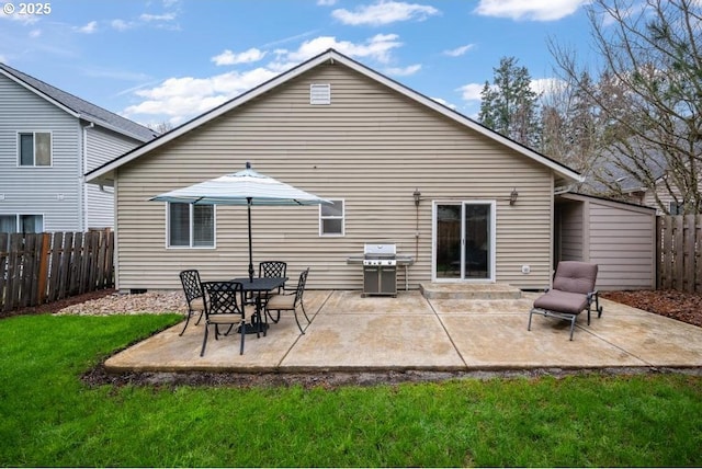 back of property featuring a patio, a lawn, and fence