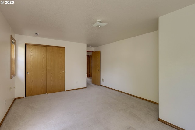 2907 NE 166th Pl, Vancouver, WA 98682 - unfurnished bedroom featuring light colored carpet, a closet, baseboards, and a textured ceiling