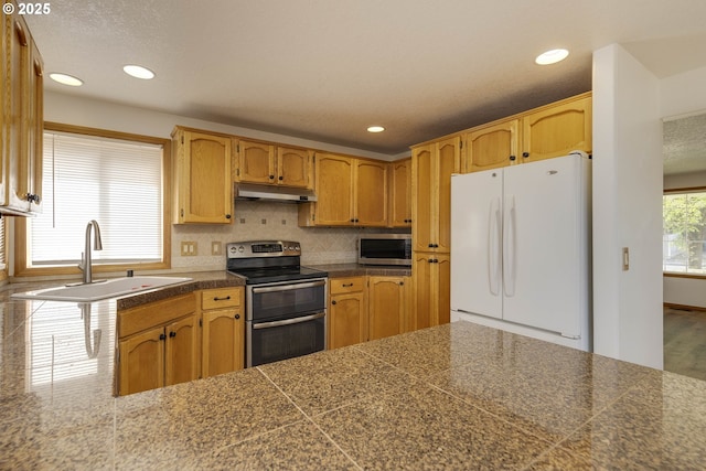 2907 NE 166th Pl, Vancouver, WA 98682 - kitchen featuring appliances with stainless steel finishes, tile counters, a sink, under cabinet range hood, and recessed lighting
