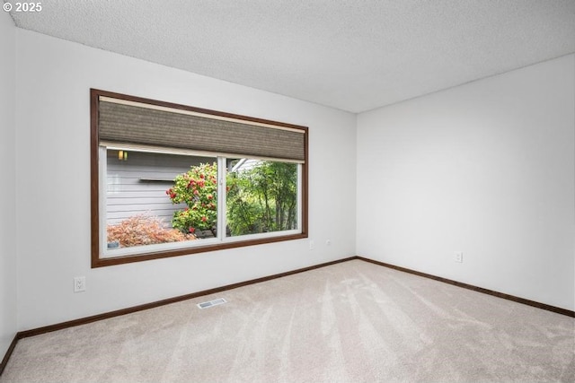 9998 SW French Prairie Rd, Wilsonville, OR 97070 - carpeted empty room featuring visible vents, a textured ceiling, and baseboards
