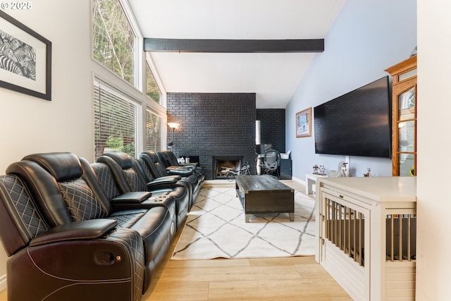 living room with beamed ceiling, light wood-style flooring, high vaulted ceiling, and a healthy amount of sunlight