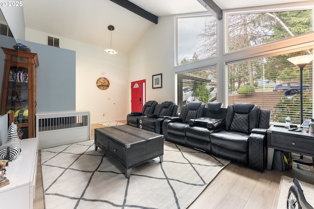 living room featuring beam ceiling, visible vents, light wood finished floors, and high vaulted ceiling