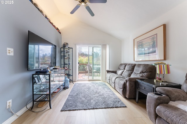 living area featuring vaulted ceiling, light wood-style flooring, a ceiling fan, and baseboards