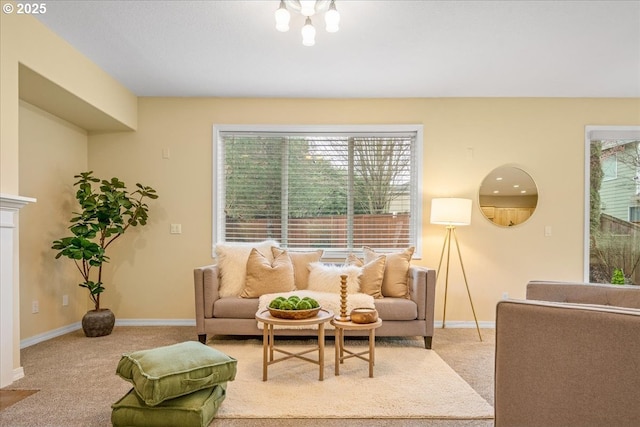 carpeted living room with baseboards