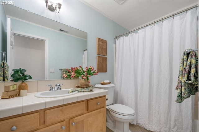 bathroom featuring vanity, a shower with curtain, visible vents, tile patterned flooring, and toilet