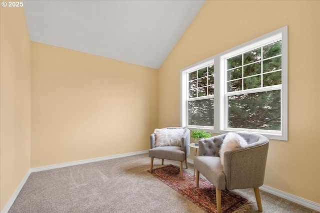 sitting room featuring baseboards, carpet, and vaulted ceiling