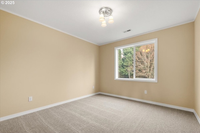 spare room featuring visible vents, carpet flooring, and baseboards