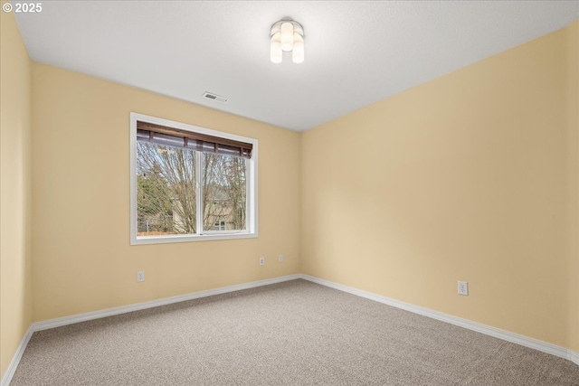 unfurnished room featuring visible vents, baseboards, and carpet