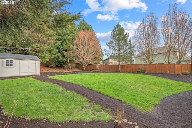 view of yard with an outbuilding, a shed, and fence