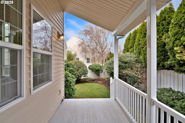 wooden deck with a lawn