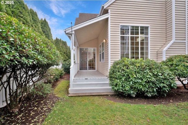 entrance to property featuring a lawn