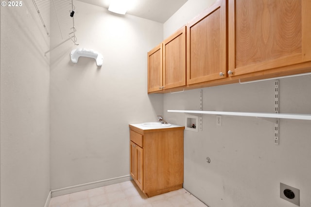 clothes washing area with cabinets, electric dryer hookup, hookup for a washing machine, and sink