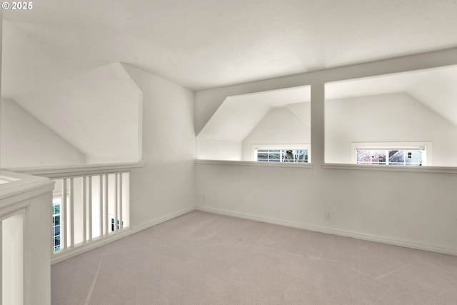 additional living space with lofted ceiling and light colored carpet