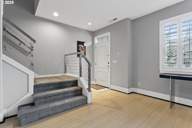 entrance foyer with hardwood / wood-style flooring and a wealth of natural light