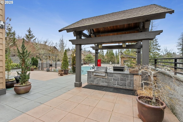 view of patio / terrace with a gazebo, area for grilling, a grill, and exterior bar