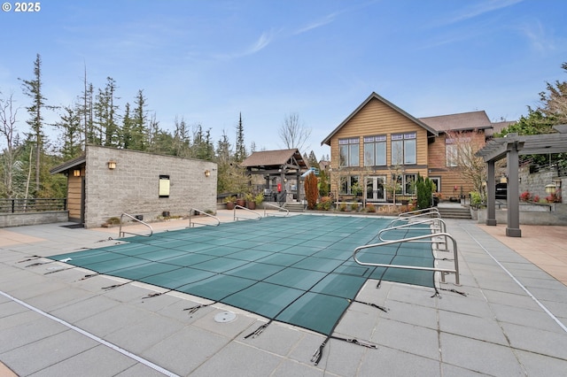 view of swimming pool with a pergola and a patio