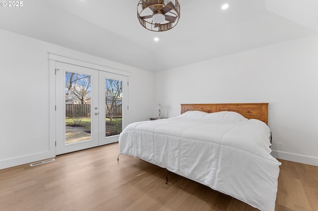 bedroom with french doors, visible vents, wood finished floors, access to outside, and baseboards