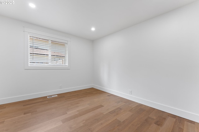 empty room with baseboards, recessed lighting, visible vents, and light wood-style floors