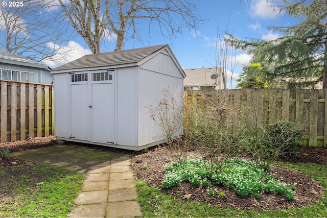 view of shed with a fenced backyard