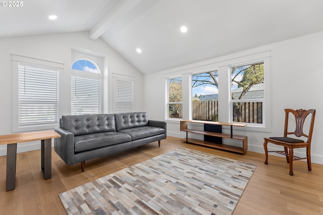 living room with lofted ceiling with beams, baseboards, wood finished floors, and a healthy amount of sunlight