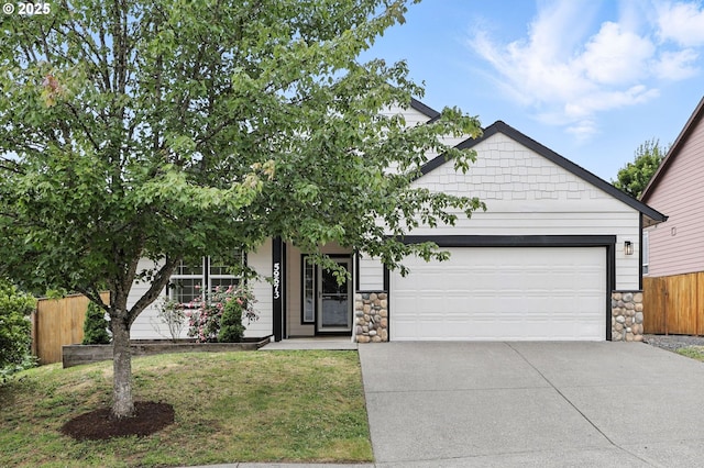 59673 Oak Ridge St, Saint Helens, OR 97051 - view of front facade featuring driveway, stone siding, and an attached garage