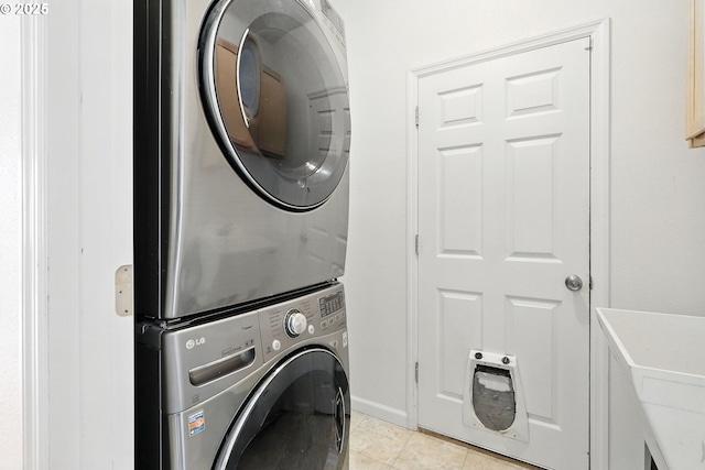 59673 Oak Ridge St, Saint Helens, OR 97051 - laundry area featuring stacked washing machine and dryer and light tile patterned floors