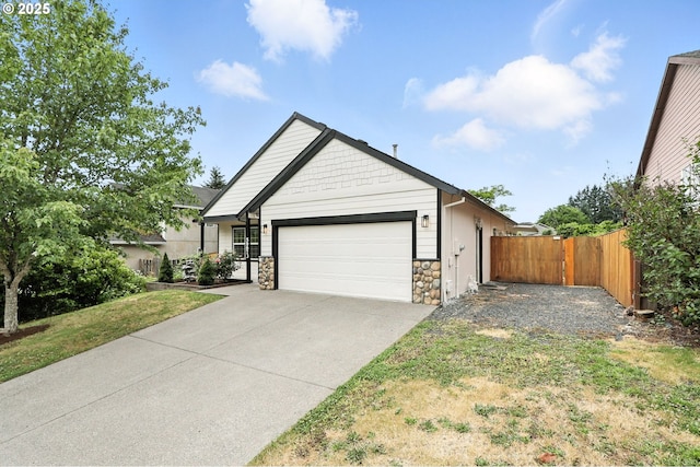 59673 Oak Ridge St, Saint Helens, OR 97051 - view of front of property featuring an attached garage, driveway, and stone siding