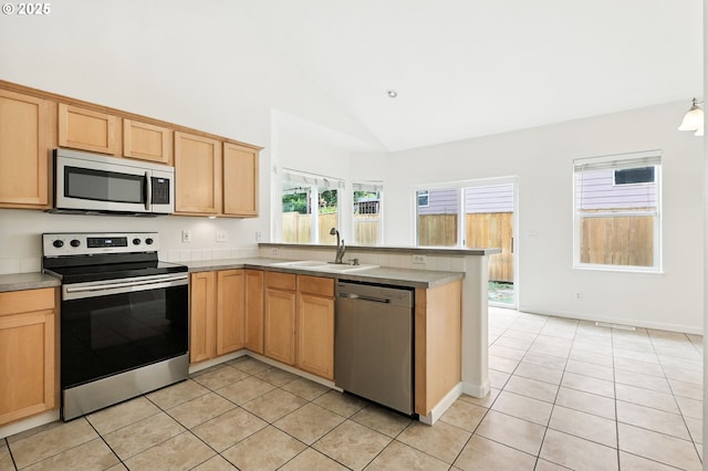 59673 Oak Ridge St, Saint Helens, OR 97051 - kitchen with stainless steel appliances, light tile patterned floors, a peninsula, high vaulted ceiling, and light brown cabinets