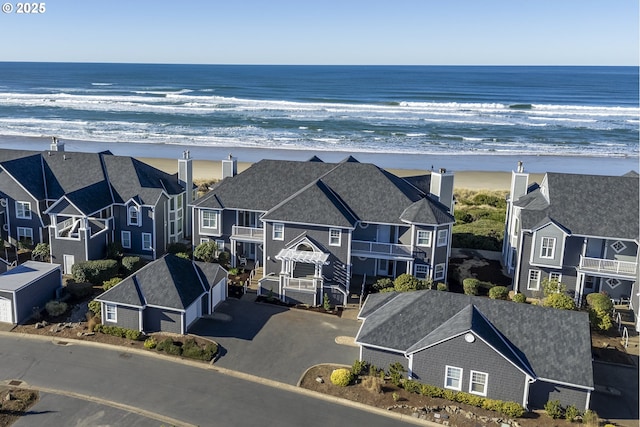 exterior space featuring a water view and a view of the beach