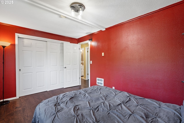 bedroom featuring wood finished floors and a closet