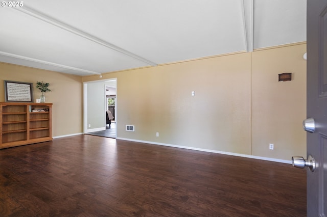empty room with wood finished floors and baseboards