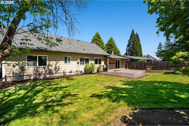 rear view of property featuring a patio area and roof with shingles