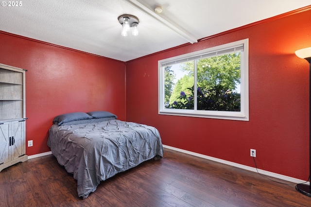 bedroom featuring wood finished floors, baseboards, and beam ceiling