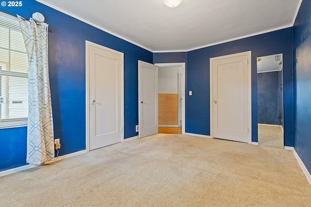 unfurnished bedroom featuring multiple windows, ornamental molding, and carpet