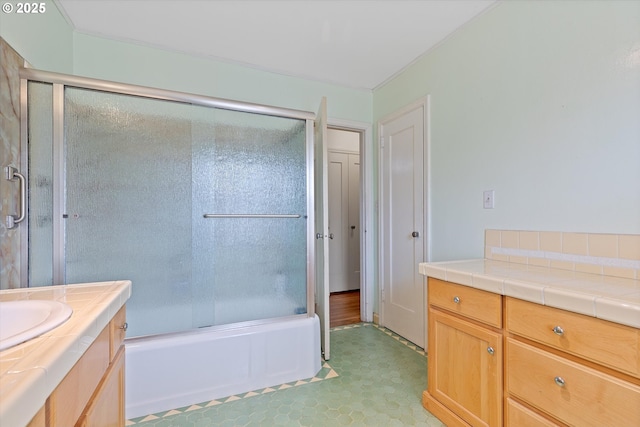 bathroom with enclosed tub / shower combo and vanity