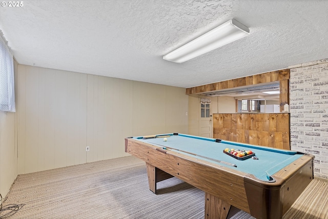 rec room featuring light carpet, billiards, and a textured ceiling