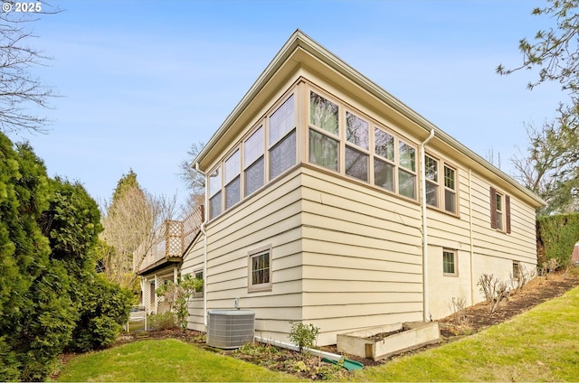 view of home's exterior featuring a yard and central air condition unit