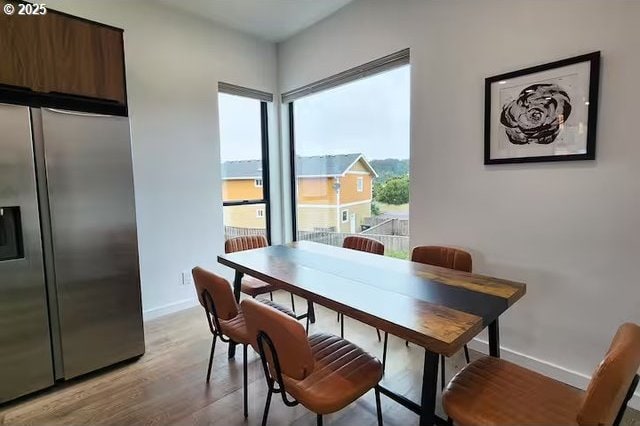 280 NW Huckleberry St, Waldport, OR 97394 - dining area with baseboards and light wood finished floors