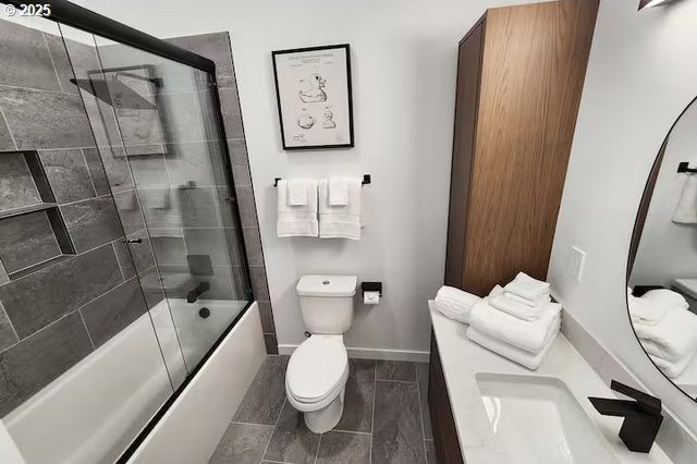 280 NW Huckleberry St, Waldport, OR 97394 - full bathroom with toilet, combined bath / shower with glass door, vanity, and baseboards