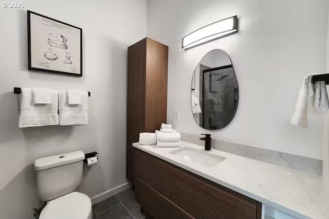 280 NW Huckleberry St, Waldport, OR 97394 - bathroom with vanity, toilet, and baseboards