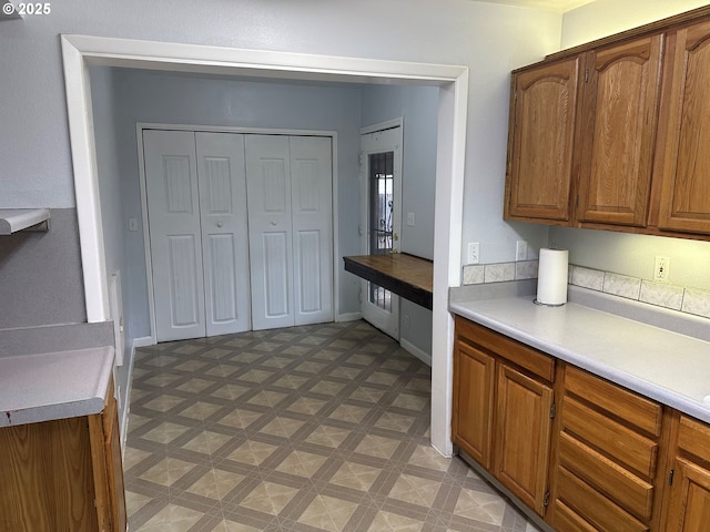 2735 W Jay Ave, Roseburg, OR 97471 - kitchen with light flooring, light countertops, brown cabinetry, and baseboards